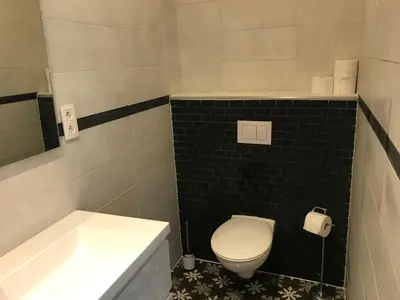 a bathroom with a toilet and a sink and a tub at Lyves Two in Liège