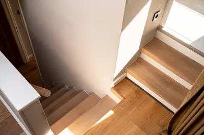 an empty room with a staircase and a window at Maas Suites (Maastricht - Lanaken) in Lanaken