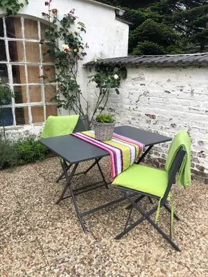 a table and two chairs with a tablecloth on it at 33 Paveestraße in Eupen