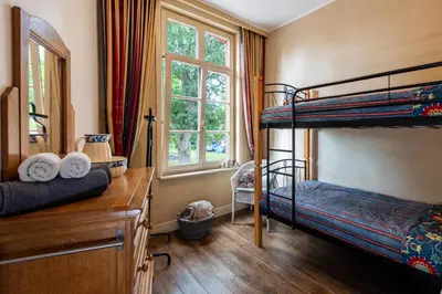 a bedroom with two bunk beds and a window at Stadshuisje 36 in Hasselt