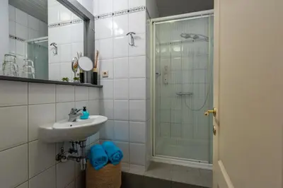 a bathroom with a sink and a shower at Stadshuisje 36 in Hasselt