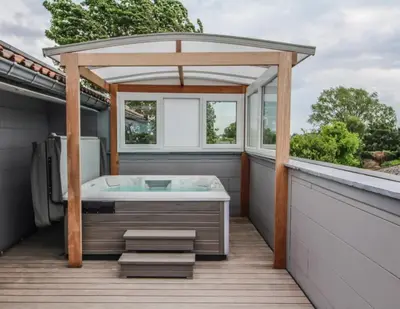 a gazebo with a bath tub on a deck at LA BINAMERIE in Remicourt
