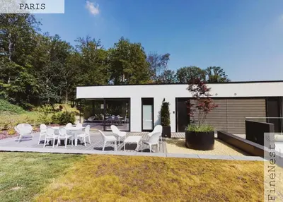 a patio with white chairs and tables in front of a house at Résidence de 3 appartements luxueux - 2 ch x 3 - 