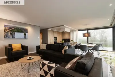a living room with a couch and a table at Résidence de 3 appartements luxueux - 2 ch x 3 - 