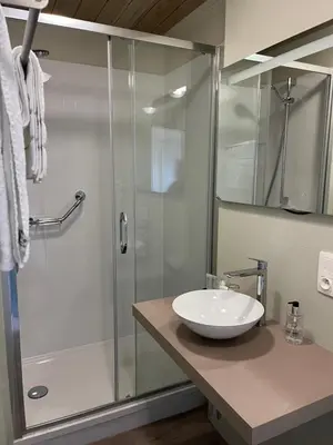 a bathroom with a glass shower and a sink at Gasthof De Statie in Wilderen