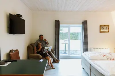 a man and a woman sitting in a living room at Gasthof De Statie in Wilderen