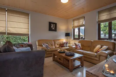 a living room with couches and a coffee table at Vakantiewoning ‘t Reigersnest in Zonhoven