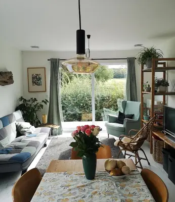 a living room with a couch and a table with flowers on it at Wetterdelle Lodge in Heers