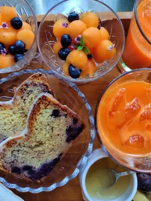a table topped with bowls of bread and fruit at Wetterdelle Lodge in Heers