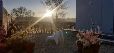 a white chair sitting in a yard with plants at Wetterdelle Lodge in Heers