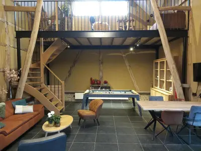 a living room with a pool table and a loft at De Bonderbei in Wellen