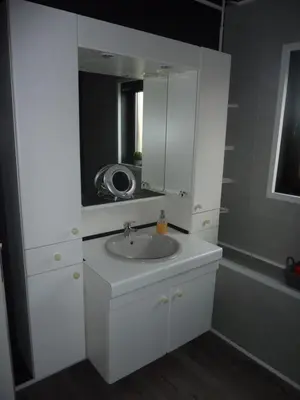 a bathroom with a white sink and a mirror at Vakantie woning De Loft in Dilsen-Stokkem