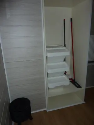 a closet with white shelves and a mop at Vakantie woning De Loft in Dilsen-Stokkem