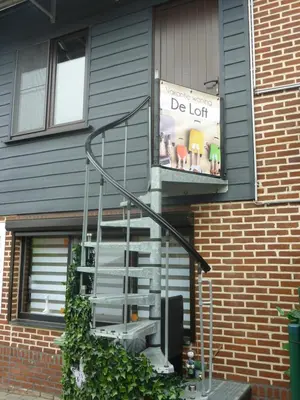 a house with a staircase with a sign that says be left at Vakantie woning De Loft in Dilsen-Stokkem