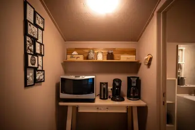 a small table with a microwave on top of it at Chalet de bosuil in Zutendaal