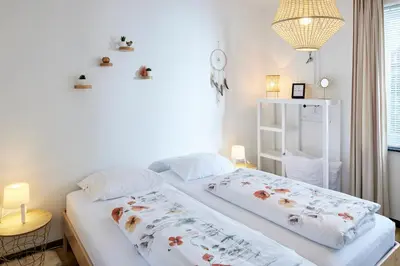 a bedroom with a bed with two pillows on it at Vakantiehuis Elisa in Alken