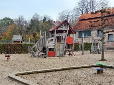 a playground with a slide and a house at CASA Victoria in Kuringen