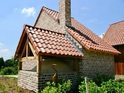 a house with a duck in the front yard at Boerderaaj in Bilzen