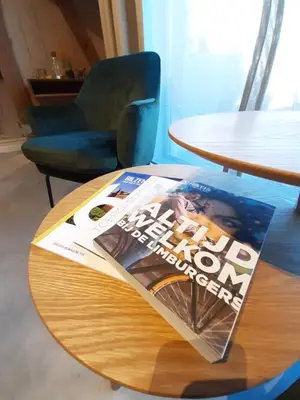 a magazine sitting on top of a wooden table at Boerderaaj in Bilzen