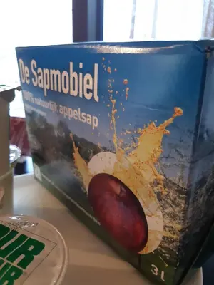 a box of food with a apple on a table at Boerderaaj in Bilzen