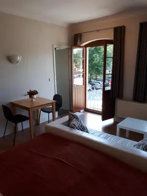 a hotel room with a bed and a table and a door at Guesthouse Dusart in Hasselt