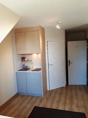 an empty apartment with a kitchen and a door at Guesthouse Dusart in Hasselt