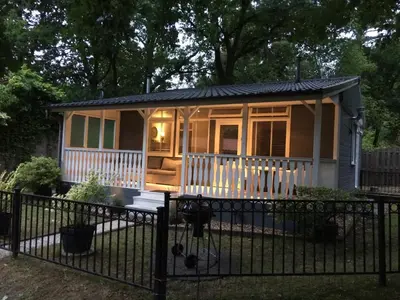 a tiny house with a porch and a fence at Chalet Belvedere in Lanaken in Lanaken