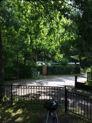 a gate in front of a park with trees at Chalet Belvedere in Lanaken in Lanaken
