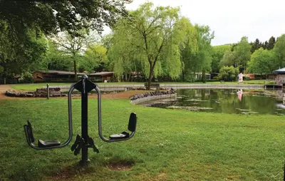 a putter in the grass next to a pond at Chalet Belvedere in Lanaken in Lanaken