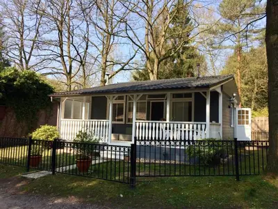 a small house with a fence in a yard at Chalet Belvedere in Lanaken in Lanaken