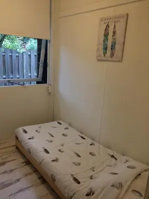 a bed in a room with a window at Chalet Belvedere in Lanaken in Lanaken