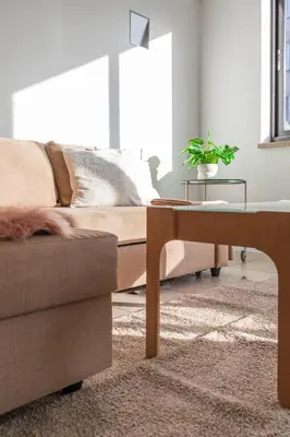 a living room with a couch and a table at Esplanada Studios in Genk