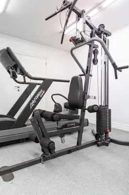 a gym with a treadmill and a elliptical machine at Esplanada Studios in Genk