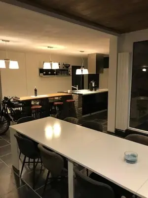 a kitchen with a large white table and chairs at Bij de lindeboom in Maaseik