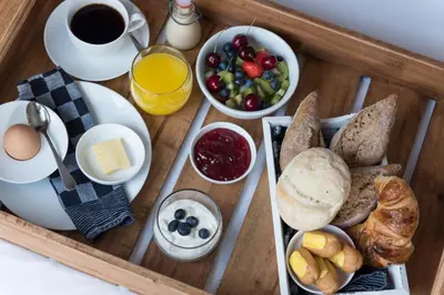 a tray of breakfast food with bread and a cup of coffee at B&B 4 Seasons in Riemst