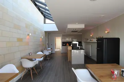a restaurant with tables and chairs and a refrigerator at B&B 4 Seasons in Riemst