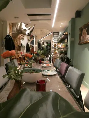 a dining room with a long table with chairs at BareFoodGIULIA - Inspiration Hotel in Hasselt