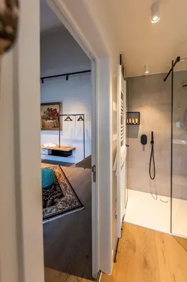 a bathroom with a shower and a glass door at BareFoodGIULIA - Inspiration Hotel in Hasselt