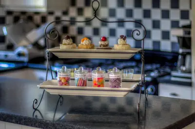 a tray of desserts on a counter in a kitchen at Vakantiehuis Aen de Roderburgh in Maaseik