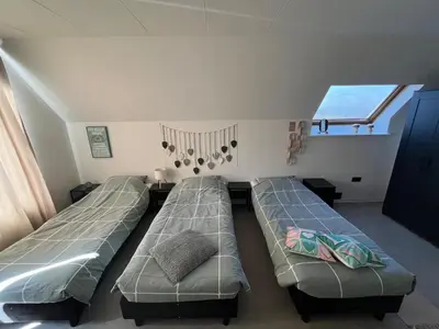 a room with two beds and a window at GT Lounge in Heusden - Zolder