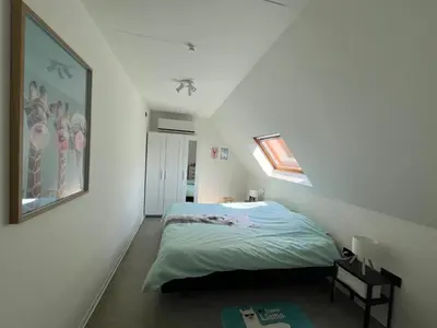 a white bedroom with a bed and a window at GT Lounge in Heusden - Zolder