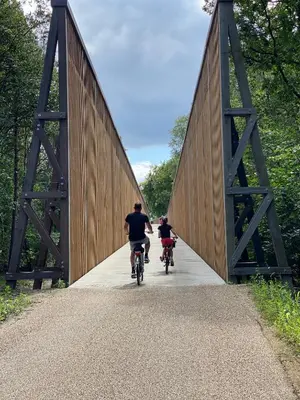 a man and a child riding bikes on a bridge at ‘t Vaerthuys in Dilsen-Stokkem