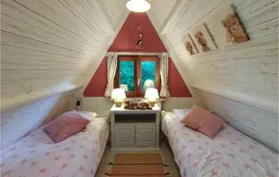 two beds in a room with red walls at Awesome Home In Rekem-Lanaken With Wifi in Bovenwezet