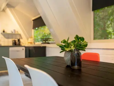 a wooden table with a vase with a plant on it at Boshuisje Rekem - Luka in Lanaken