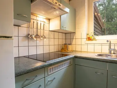 a kitchen with white cabinets and a sink at Boshuisje Rekem - Luka in Lanaken