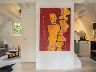 a painting of a man on a wall in a living room at Boshuisje Rekem - Luka in Lanaken