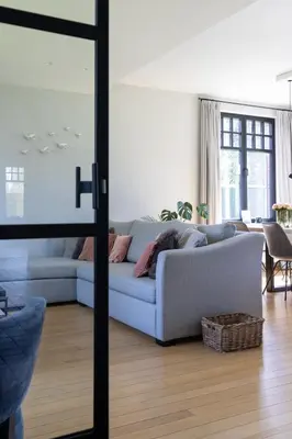 a living room with a blue couch in a living room at De Sjieper in Lanaken