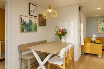 a dining room with a table and chairs at Center Parcs Erperheide in Peer
