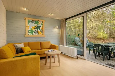 a living room with a couch and a table at Center Parcs Erperheide in Peer