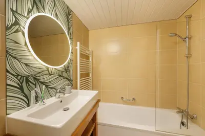 a bathroom with a sink and a mirror at Center Parcs Erperheide in Peer